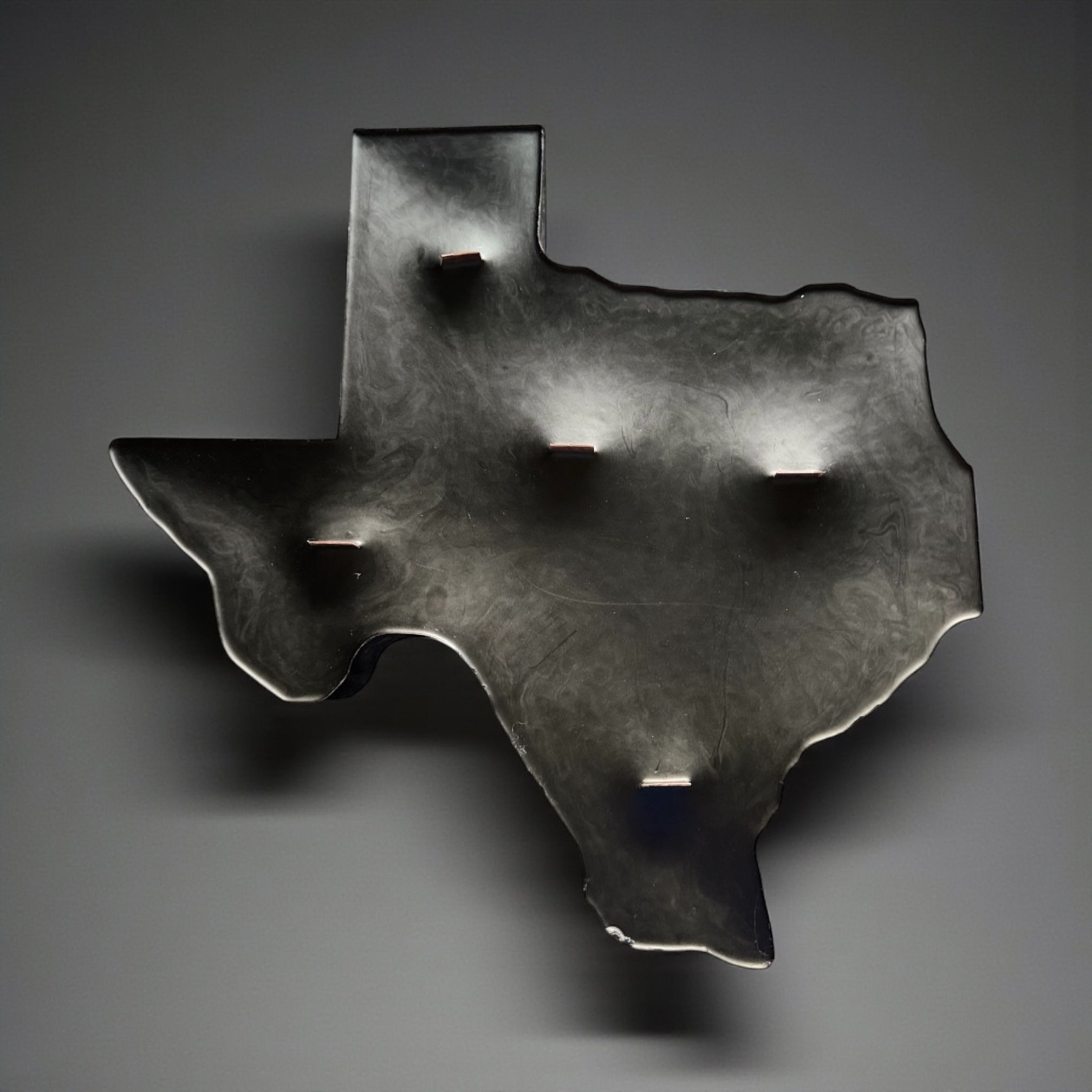 Handcrafted matte black Texas silhouette paraffin pillar candle with smoky marbled detailing and five wood wicks.