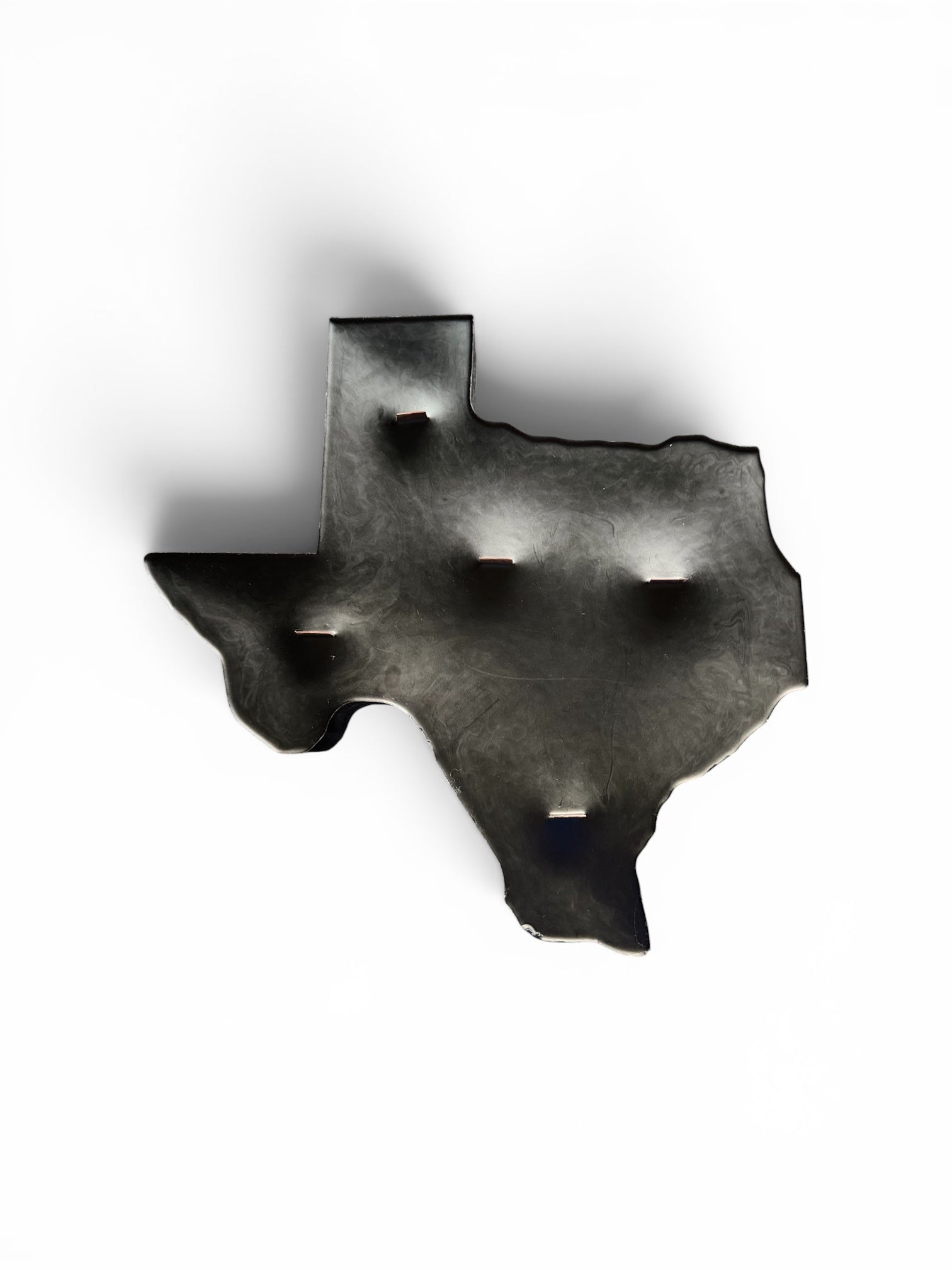 Matte black Texas silhouette paraffin pillar candle with smoky marble finish and five wood wicks on a light background.
